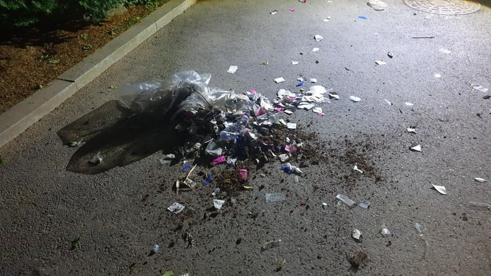Heaps of garbage on the street at night.