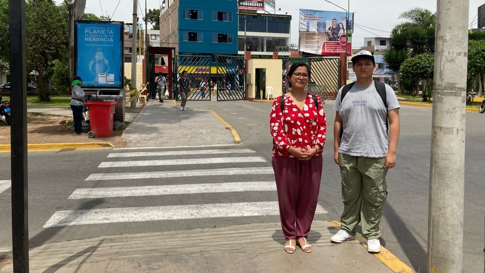 A woman and a man are standing next to each other on the street