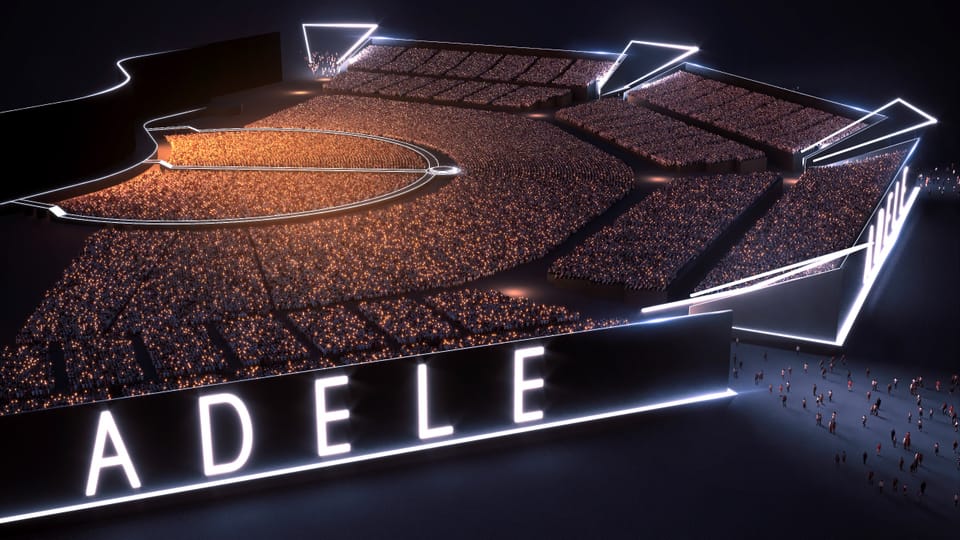 Ein Stadion mit vielen Leuten, beschriftet mit der Lecuchtschrift «ADELE».
