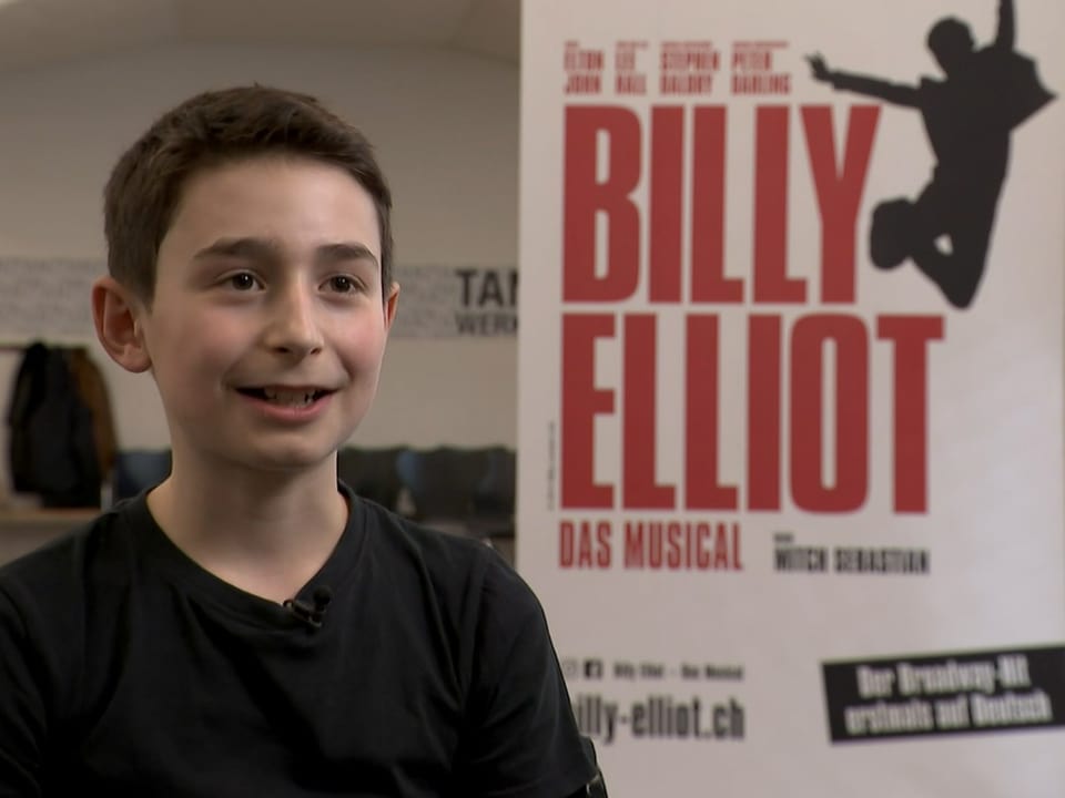 Darsteller Moritz Fischli sitzt vor einem Plakat des «Billy Elliot»-Musicals