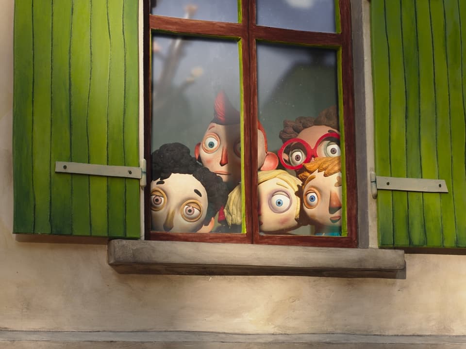 Kinder schauen aus einem Fenster.