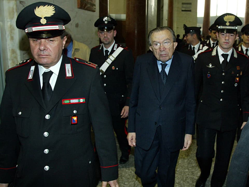 Andreotti in Begleitung von Polizisten.