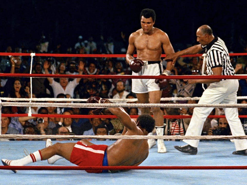 Foreman no chão, Ali olha para ele Foreman no chão, Ali olha para ele