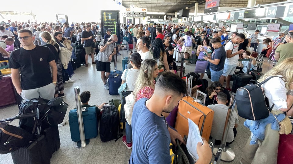 Menschen warten am Flughafen Catania.