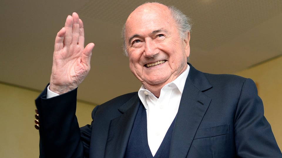 Der ehemalige Fifa-Präsident Sepp Blatter winkt lachend in die Kamera. 