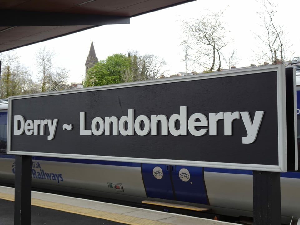 Zwei Stadtschilder, eins mit Derry, eins mit Londonderry beschriftet.