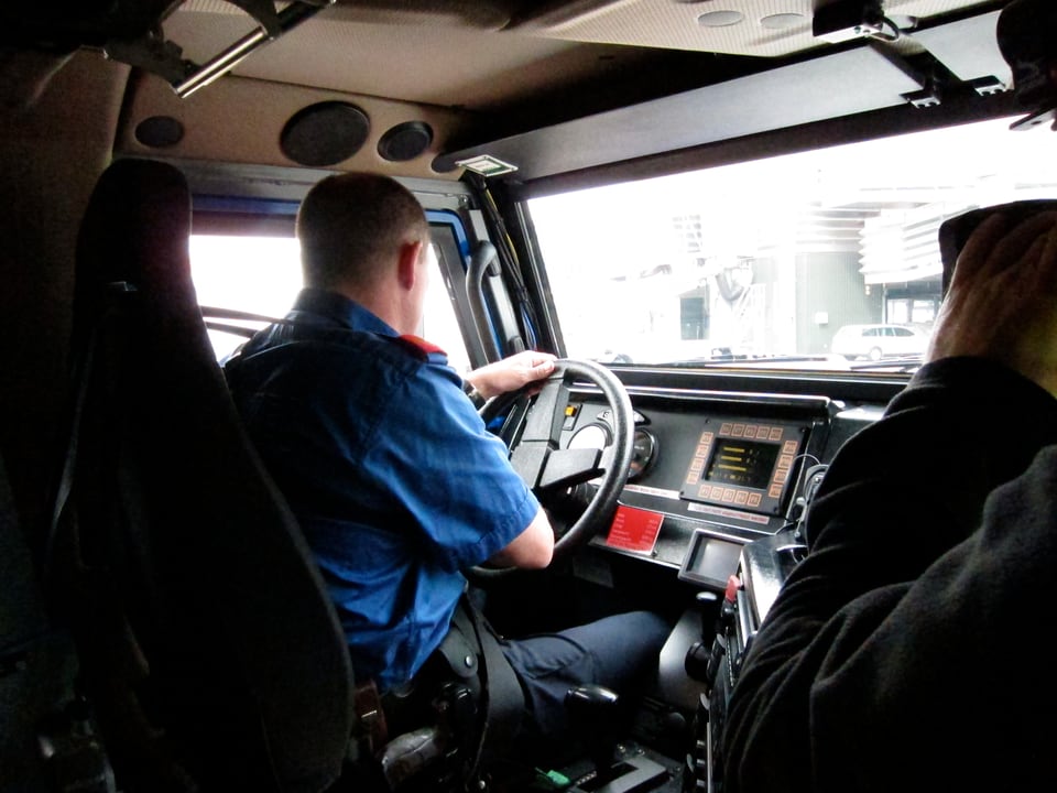Das Innere des Fahrzeugs mit Polizisten am Steuer.