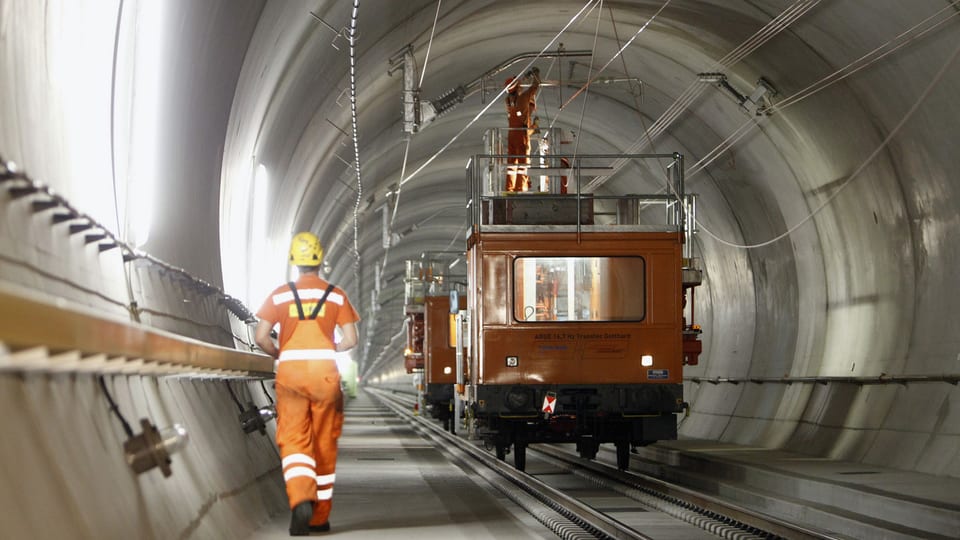 Arbeiter montieren im Streckenabschnitt Erstfeld-Sedrund des Gotthards-Basistunnels Kupferdrähte für die Fahrleitung. 