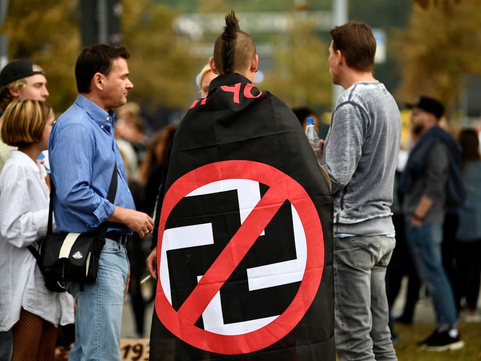Ein Mann mit einer umgehängten «Anti-Nazi-Flagge»