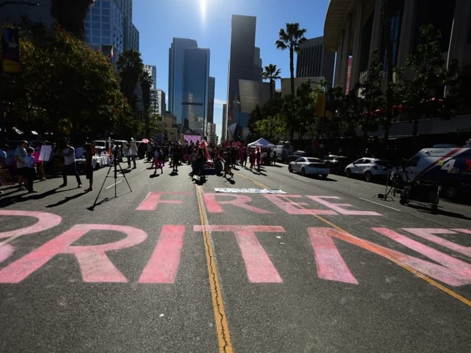 Demonstration auf der Strasse mit grossem 'Free Britney'-Schriftzug, Hochhäuser im Hintergrund