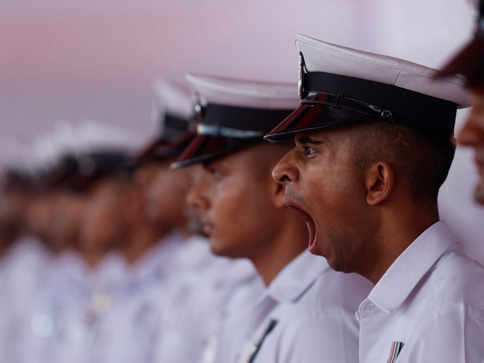 A Navy personnel yawns before the commissioning ceremony of INS Imphal in Mumbai.