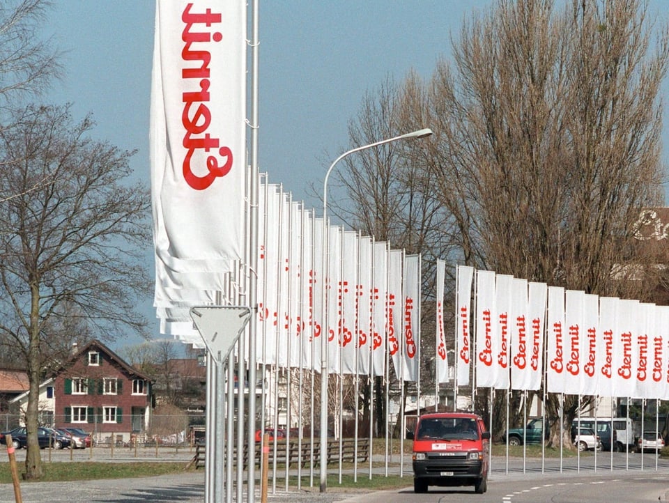 Flag-lined access road to the Eternit production site in Niederurnen