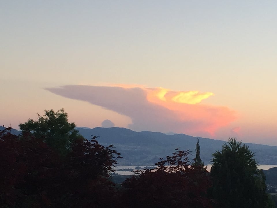 Eine einzelne Gewitterwolke türmt sich in den Abendhimmel und ist von weither sichtbar.