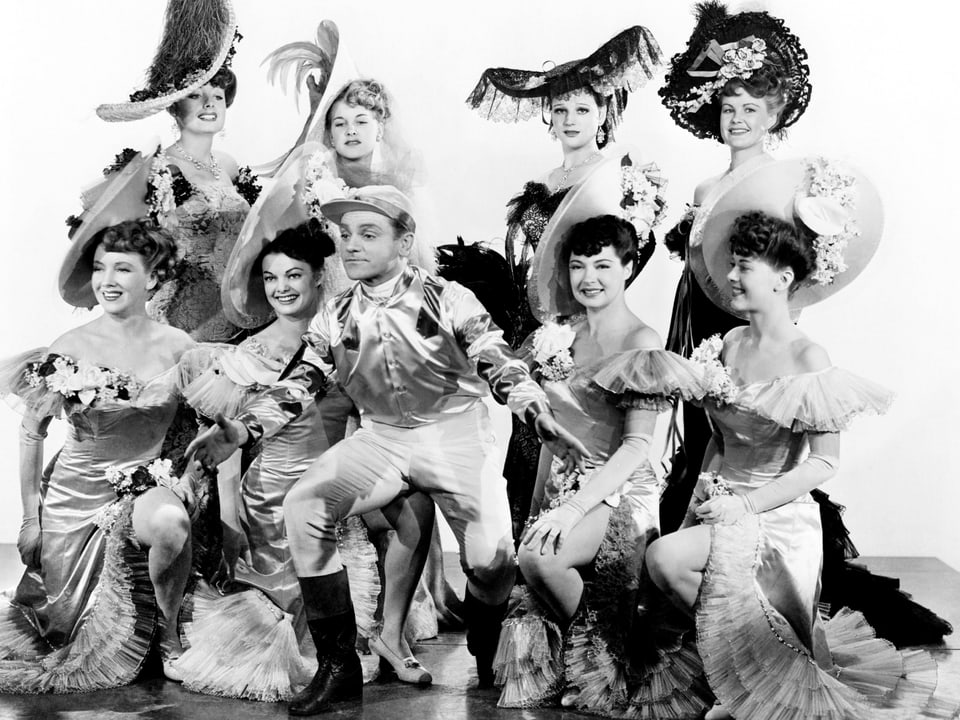 Cagney posiert, umgeben von einer Gruppe von Frauen.