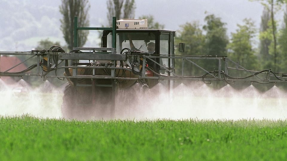 Landwirtschaftsmaschine spritzt Pestizide.