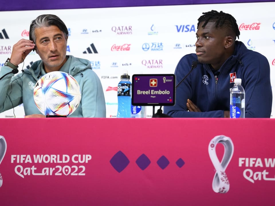 Zwei Männer sitzen bei einer Pressekonferenz der FIFA Weltmeisterschaft Katar 2022.