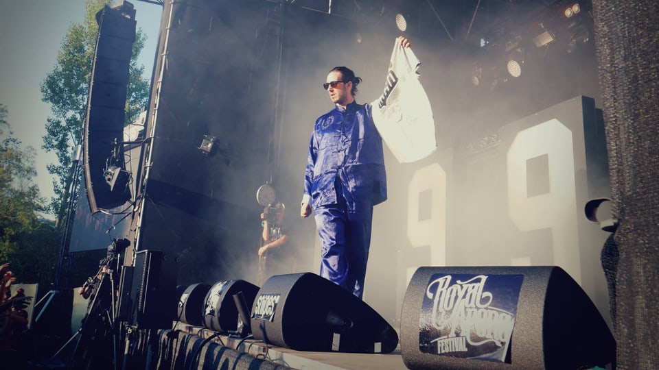Eine Bühne mit einem in einem blauen Seidenpyjama gekleideten Rapper