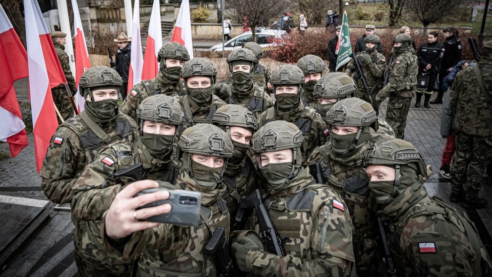 Maskierte Soldaten der Territorialverteidigung posieren für ein Selfie.