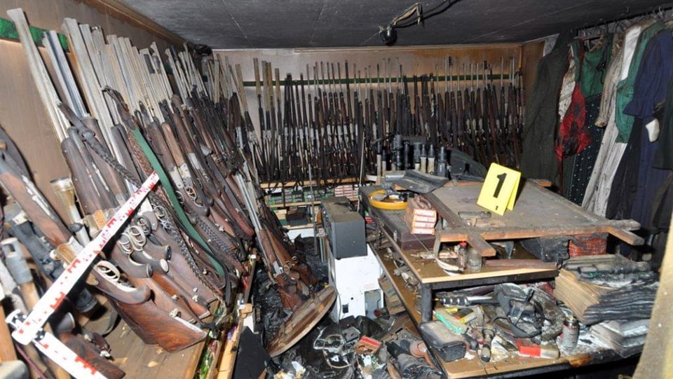 Ein kleiner Raum, an dessen Wänden diverse Gewehre stehen.