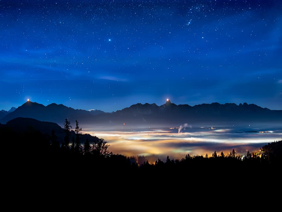 Sternennacht und Hochnebel über dem Tal