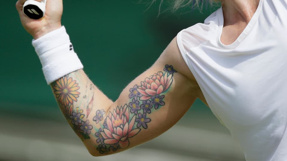 Tattoo (Blumenmotive) am Schlagarm von Mattek-Sands