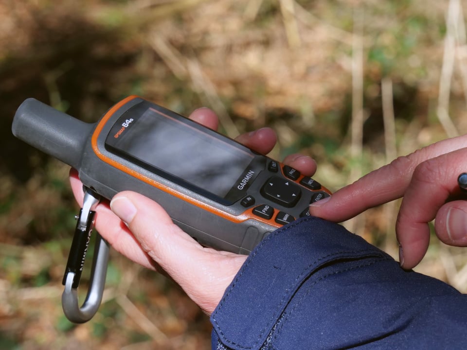 GPS-Gerät in einer Hand.