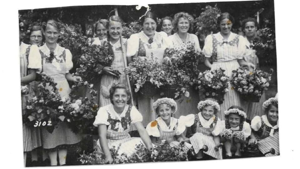 Gruppenfoto mit Mädchen und Blumenkränze.