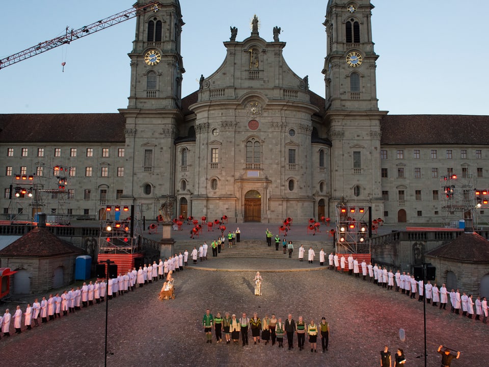 Klosterplatz Einsiedeln, rechts und links eine lange Schlange weiss gekleideter Menschen 