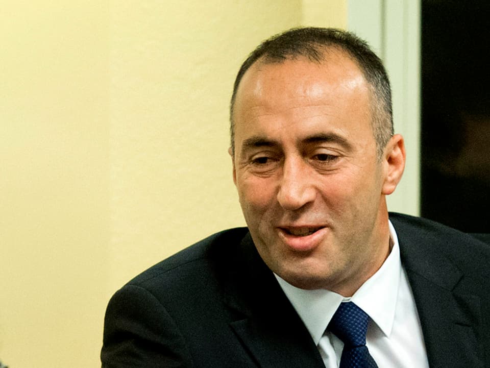 Ramush Haradinaj begrüsst per Handdruck einen anderen Mann