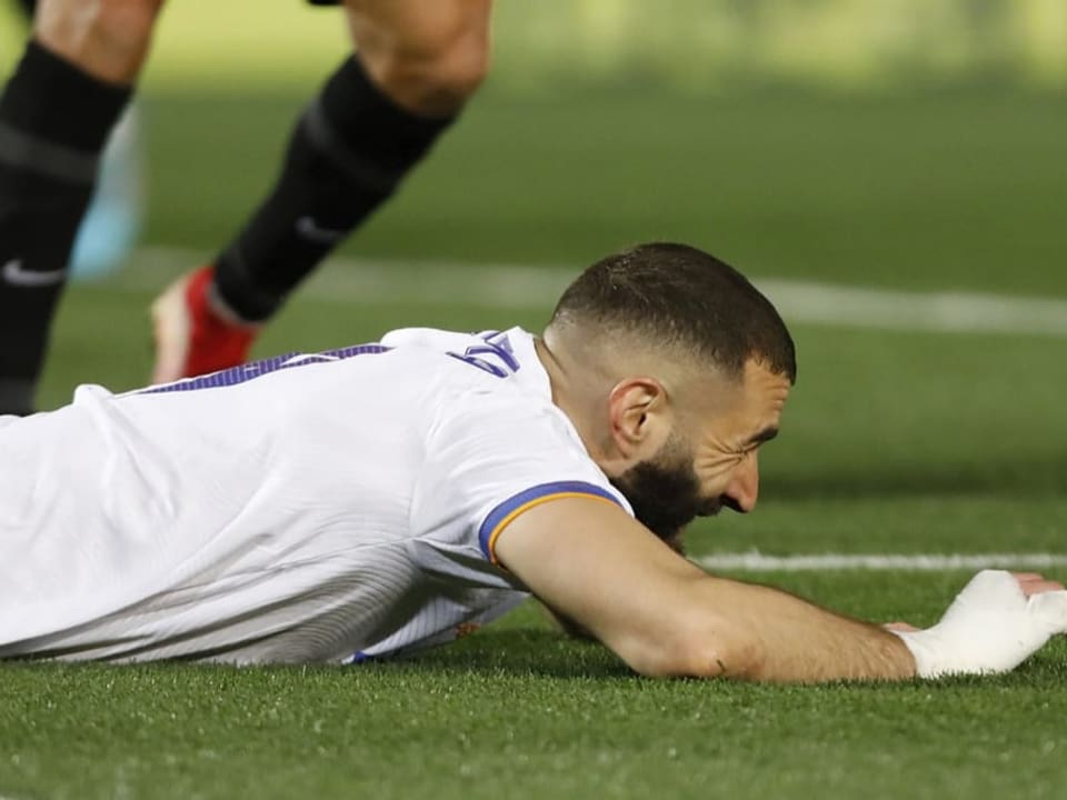 Nun auch noch Schmerzen an der Wade Karim Benzema liegt bäuchlings auf dem Rasen.
