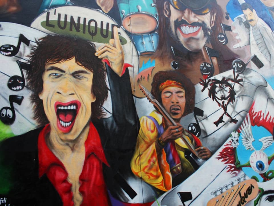 Mick Jagger, Jimmy Hendrix  und andere Musiker als Graffitis.