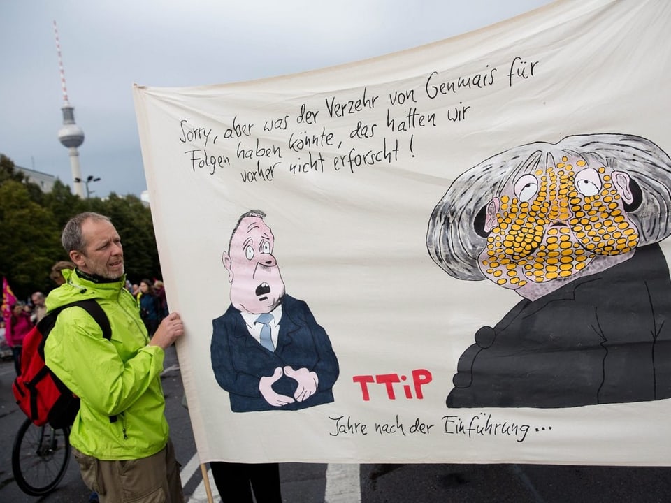 Anti-TTIP-Transparent mit Anspielung auf Gen-Mais und Merkel