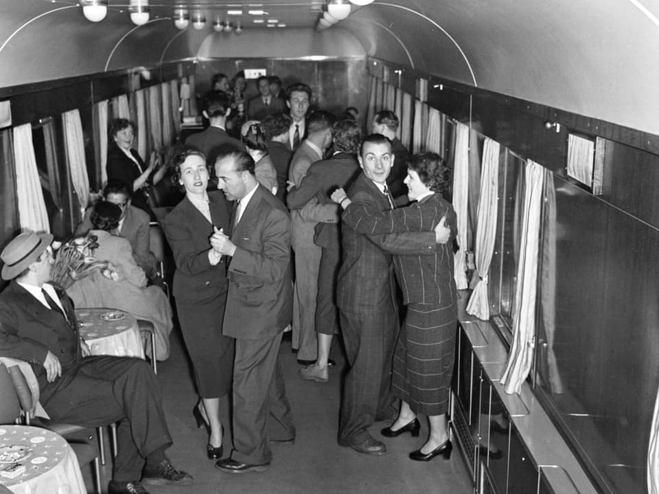 Reisende schwingen das Tanzbein im Salonwagen des Hotelplan-Expresszuges.