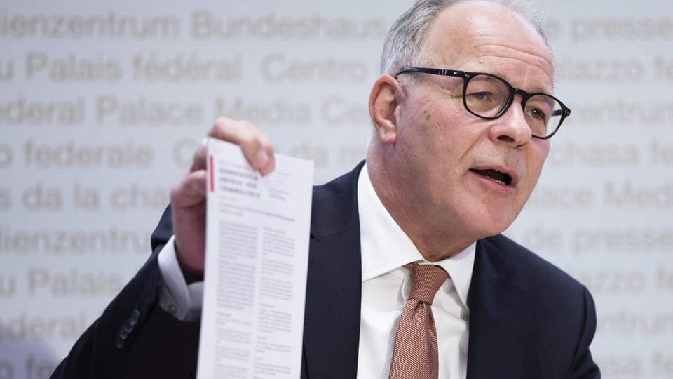 Zürcher an einem Medienkonferenz mit einem Papier in der Hand