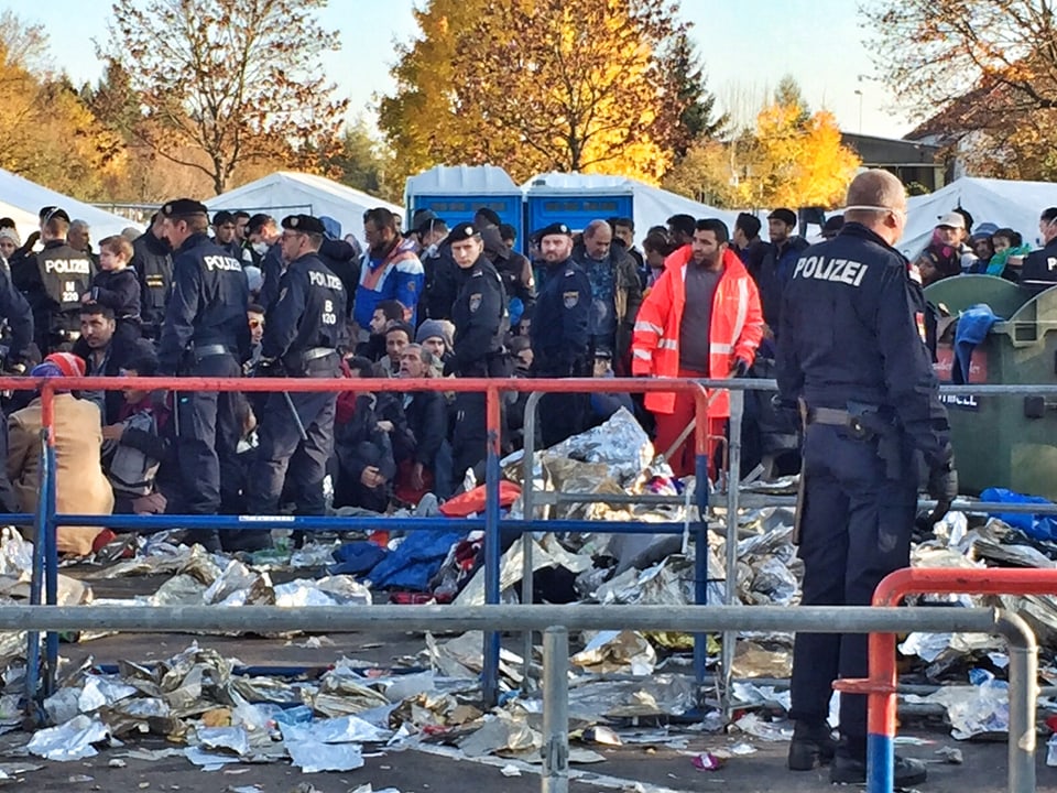 Flüchtlinge, Polizisten und Abfall am Boden.