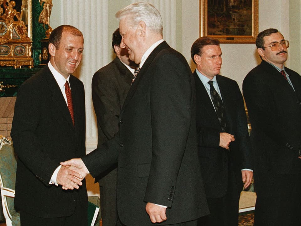 Männer schütteln dem damaligen Präsidenten Russlands, Boris Jelzin, bei einem Treffen die Hand. 