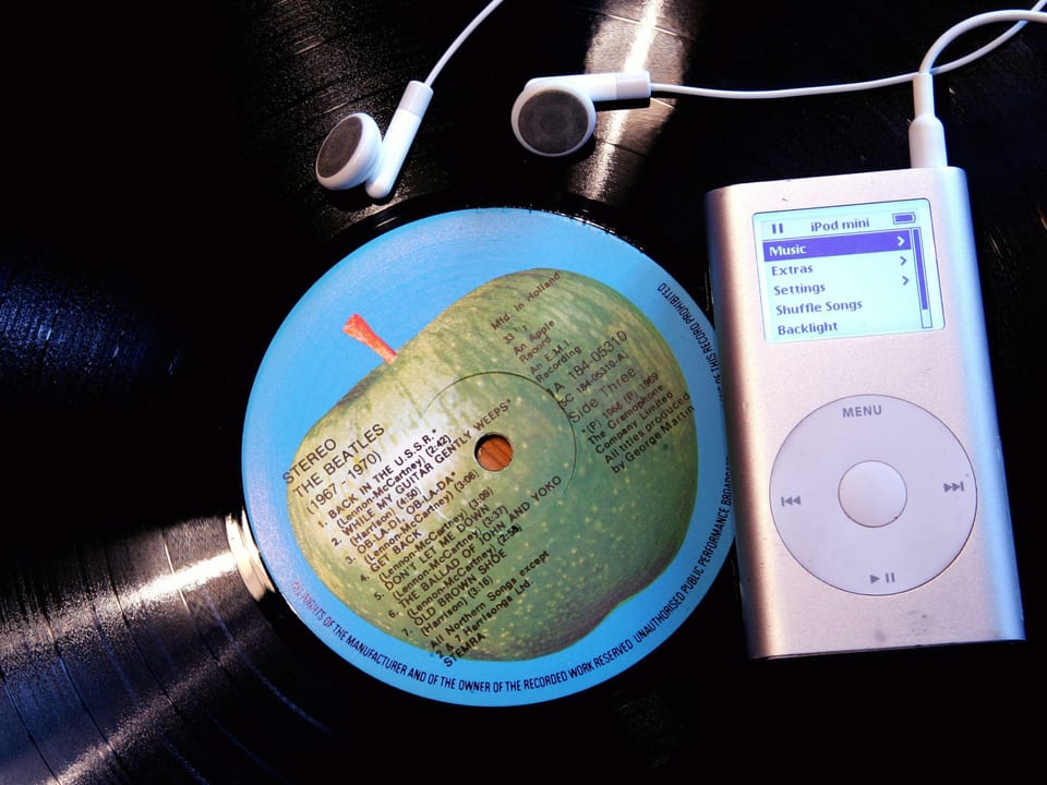 Der erste Apple iPod liegt auf eine Schallplatte.