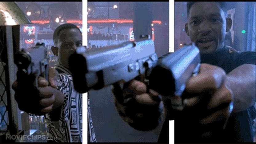 Zwei Schauspieler ziehen ihre Handfeuerwaffen und zielen auf den Betrachter.