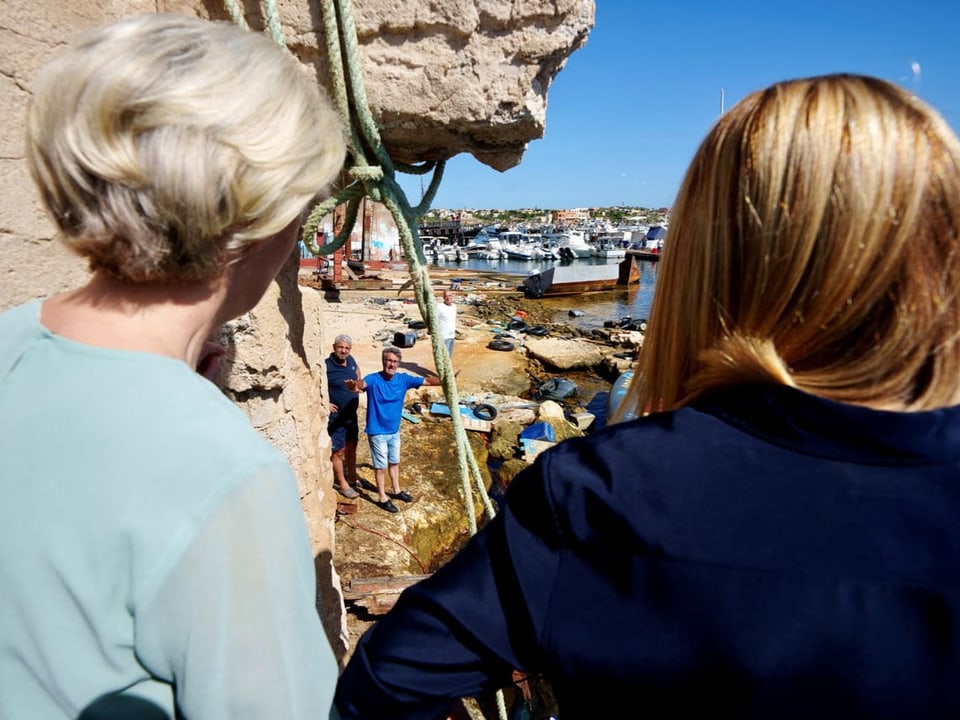 Ursula von der Leyen und Giorgia Meloni sprechen mit Mann auf Lampedusa (von hinten fotografiert)