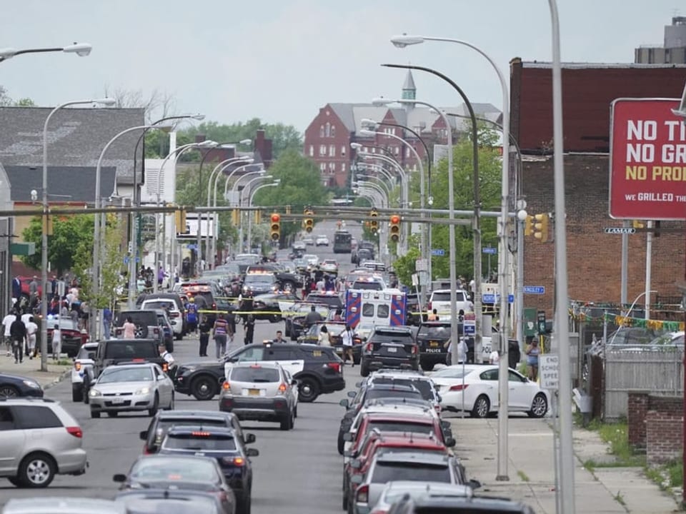 Vehicles are waiting in front of the police barrier