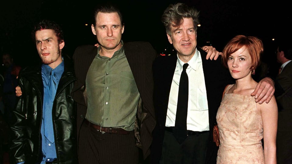 Die drei Schauspieler und David Lynch posieren Schulter an Schulter für die Kamera.