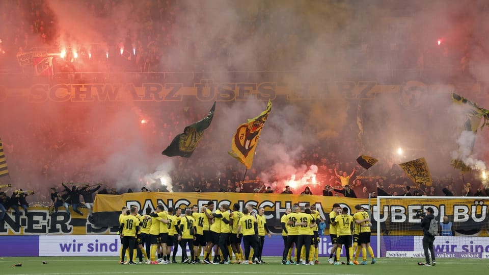 Die YB-Fussballmannschaft feiert vor ihrer Heimkurve unter Petardengeleucht und viel Rauch den Meistertitel.