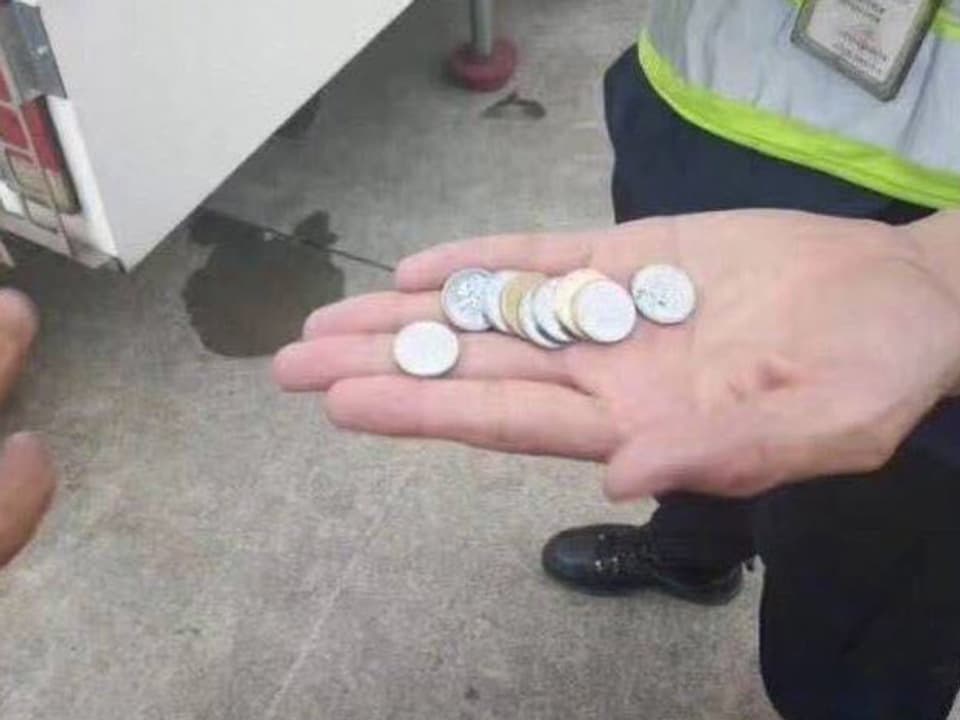 Eine Hand mit mehreren Münzen.
