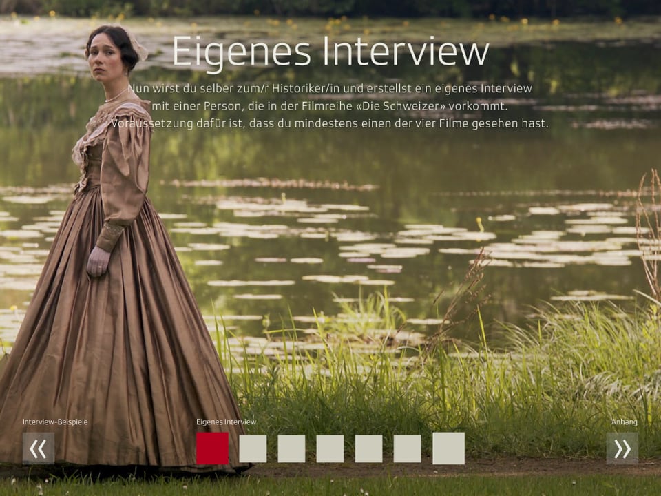 Ein Screenshot aus dem iBook zeigt eine Szene aus «Die Schweizer»: eine elegant gekleidete Frau an einem See.
