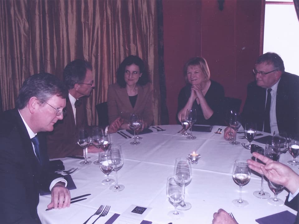 Runder Tisch mit fünf Gästen.