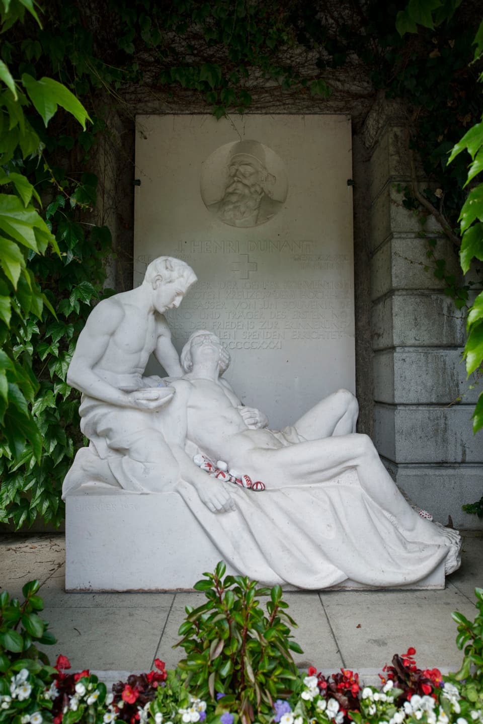 Grabstätte Henry Dunant auf dem Fiedhof Sihlfeld in Zürich. Zwei aus Stein gemeisselte Figuren.