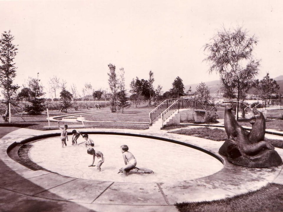 Kinder spielen in einem seichten Wasserbecken