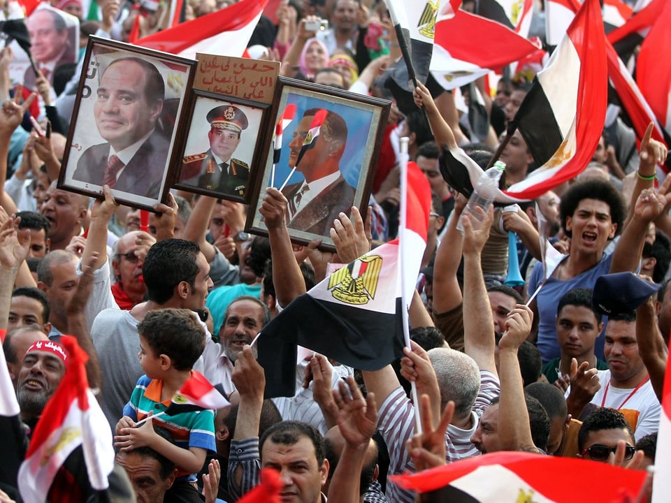 Anhänger von al-Sisi feiern mit Fahnen und Bildern von al-Sisi in der Hand