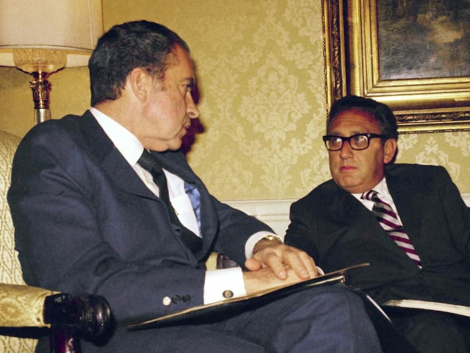Henry Kissinger sitzt rechts neben dem ehemaligen US-Präsidenten Richard Nixon.