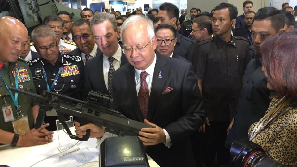 Premierminister Najib Razak ein Gewehr in der Hand haltend
